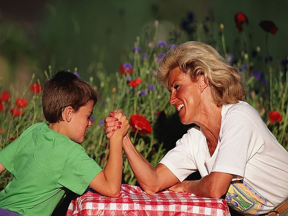 mother and son arm wrestling
