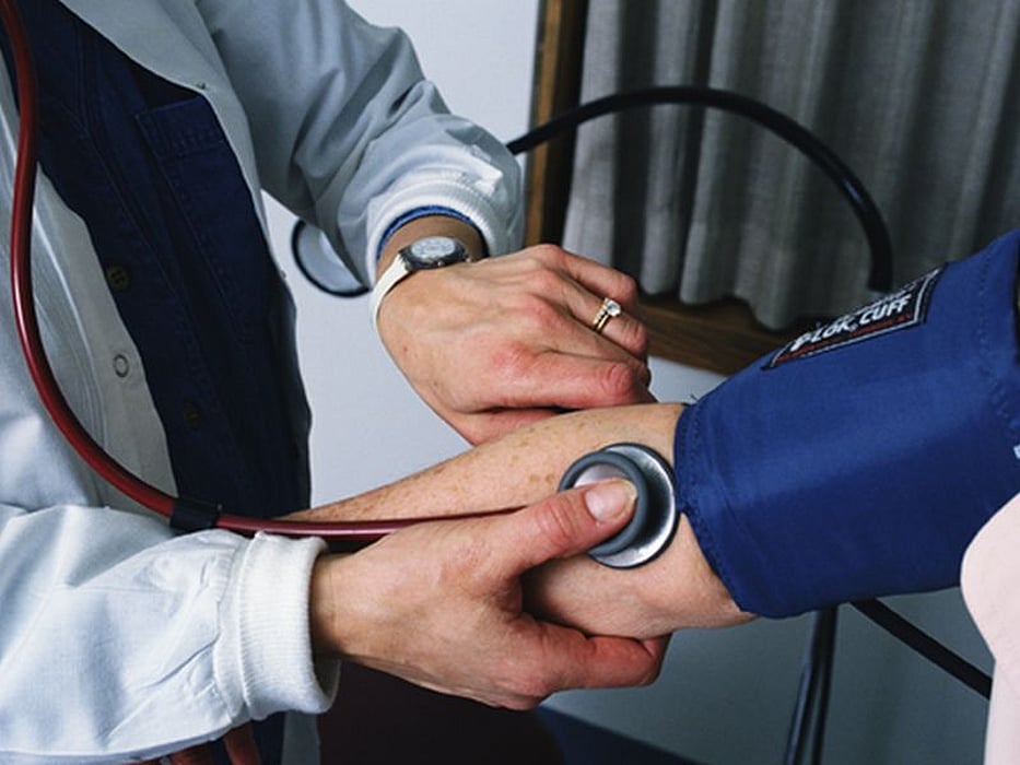 doctor checking blood pressure
