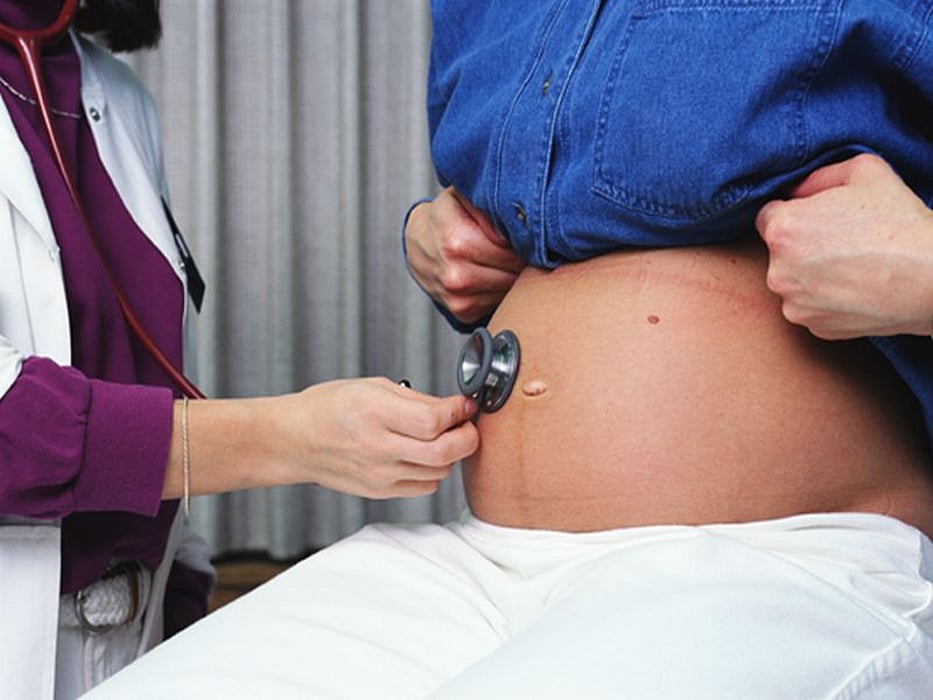 doctor examining pregnant woman