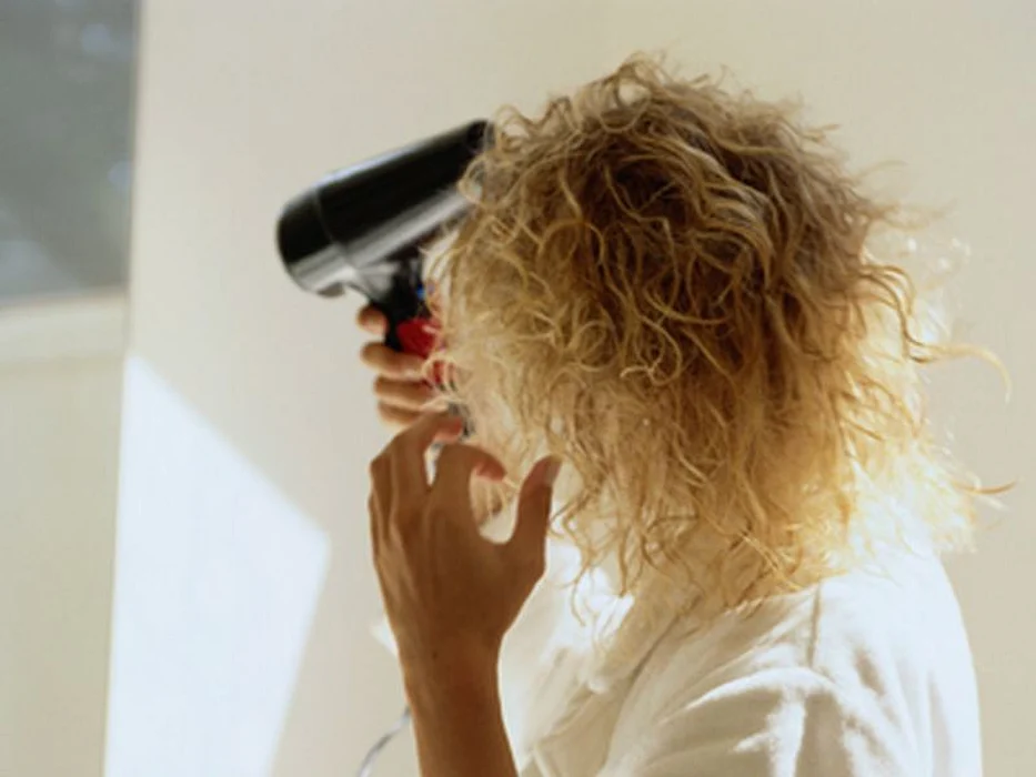 woman drying her hair
