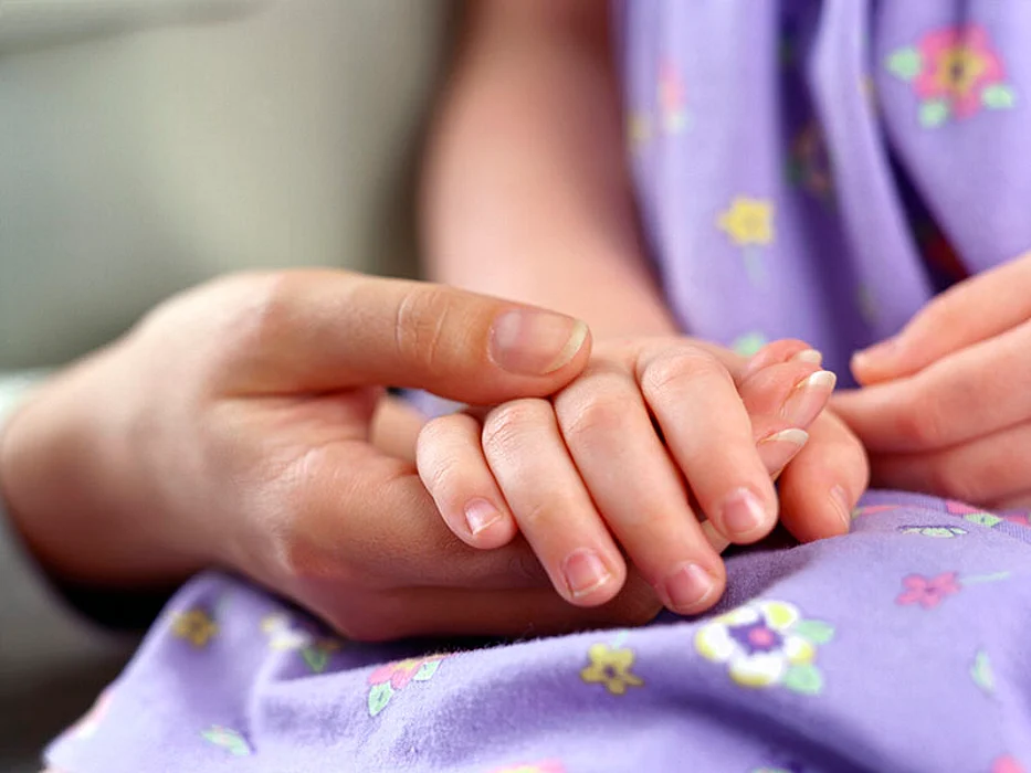 mother holding child\'s hand