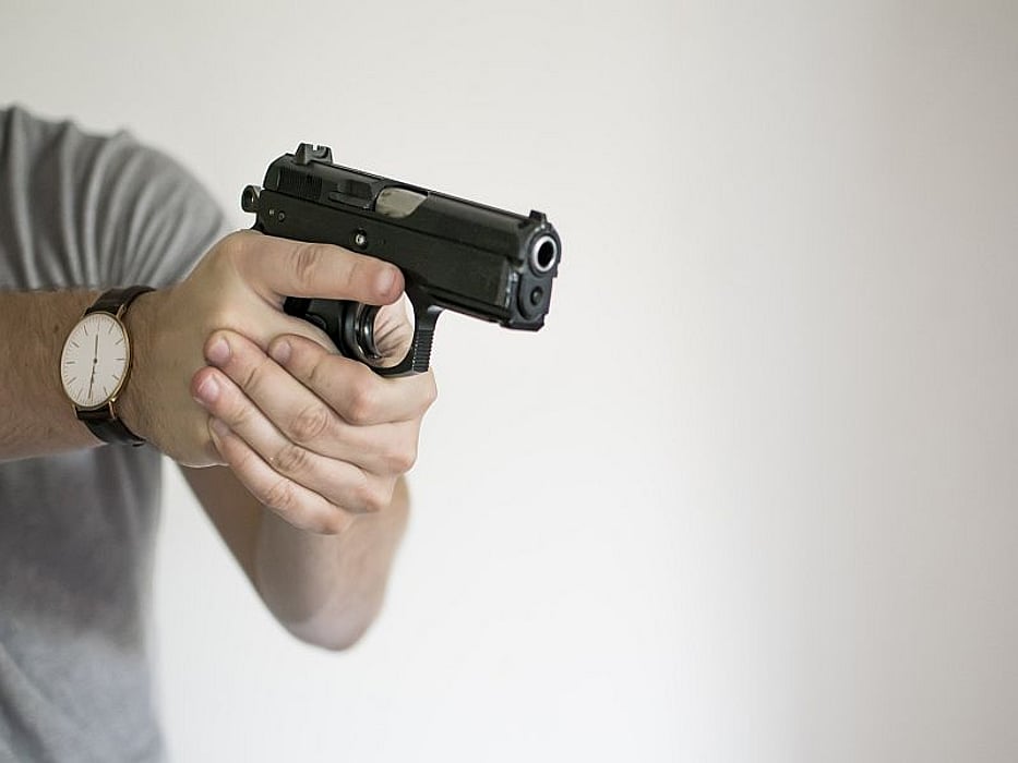 man aiming gun