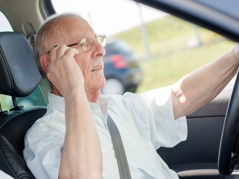 elderly driver on cell phone
