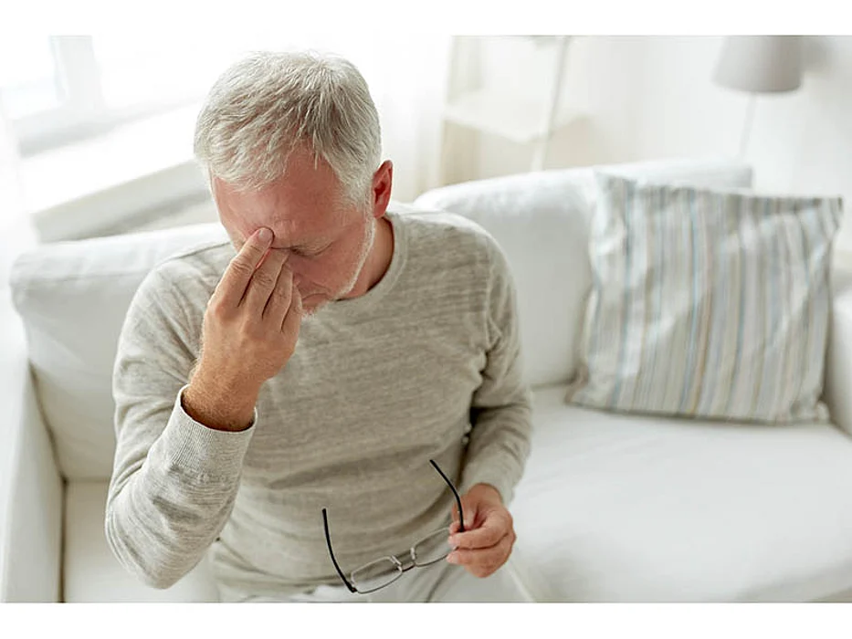 stressed man holding his head