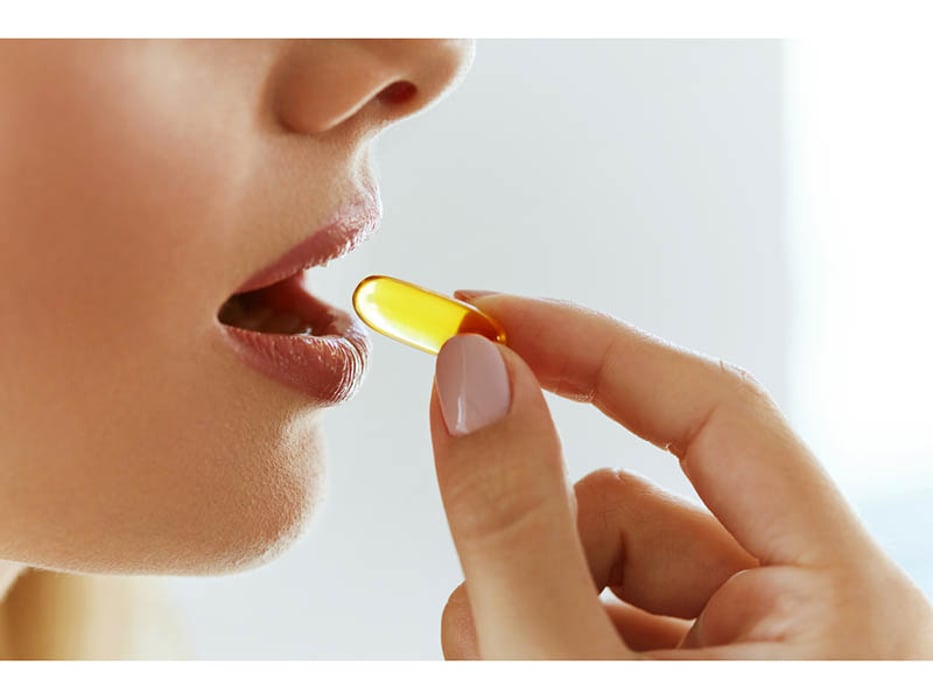 a woman taking a pill