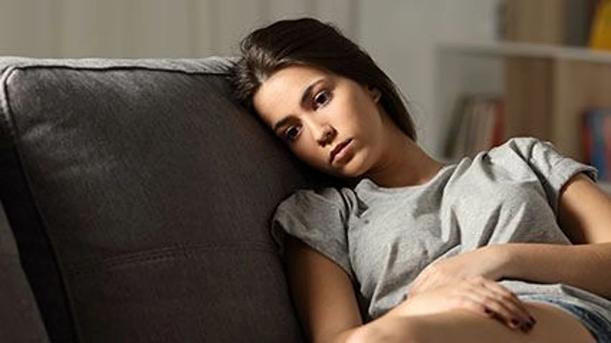 sad girl sitting on a coach