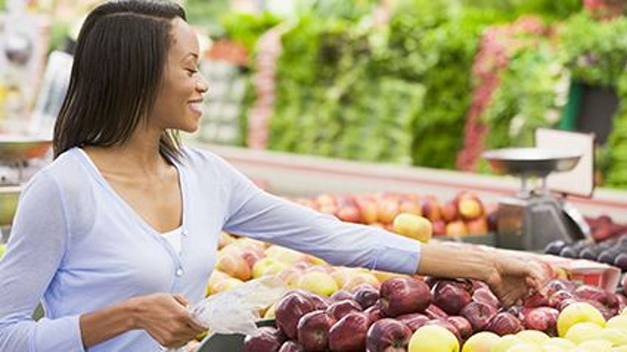 a woman shopping for fruit and vegetables in the supermarket