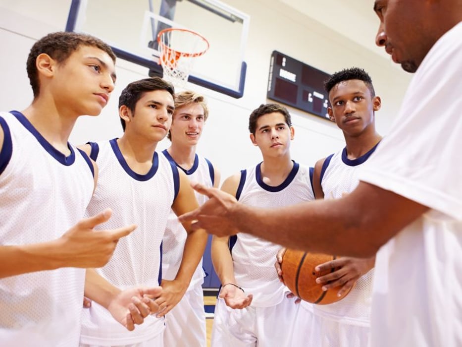 Basketball coach talks with players