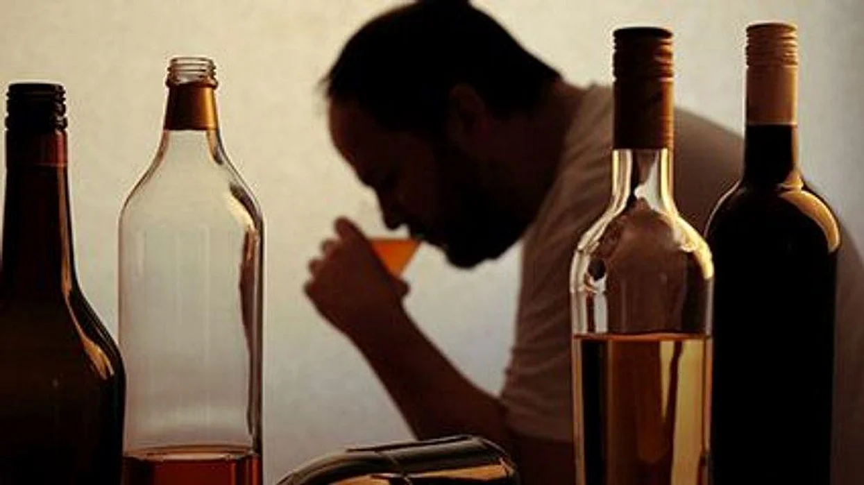 a man drinking alcohol
