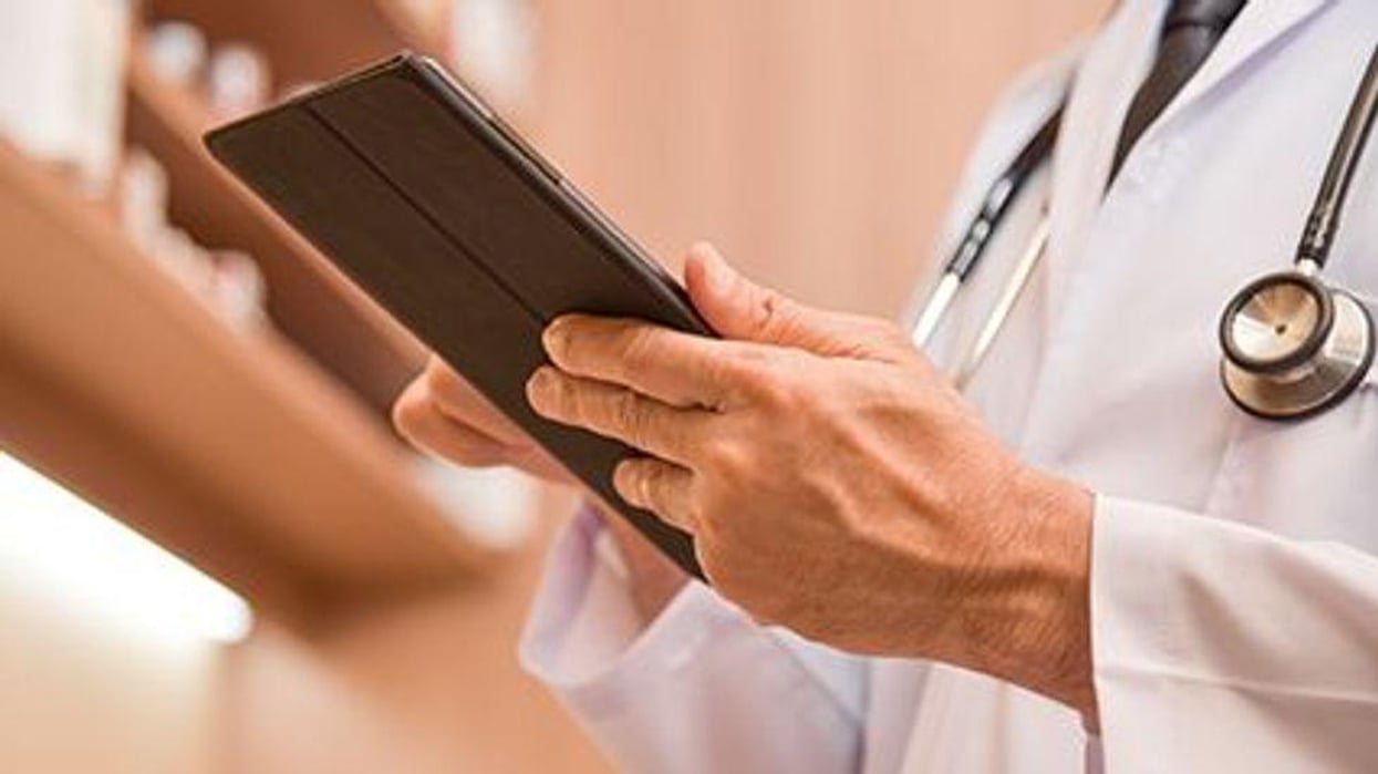 a doctor holding a tablet