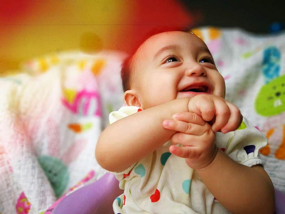 baby smiling looking up