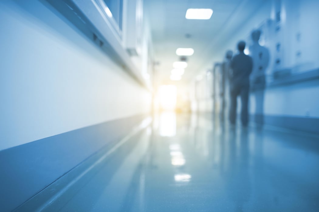 Doubled silhouette of medical worker in hospital hall, unfocused background