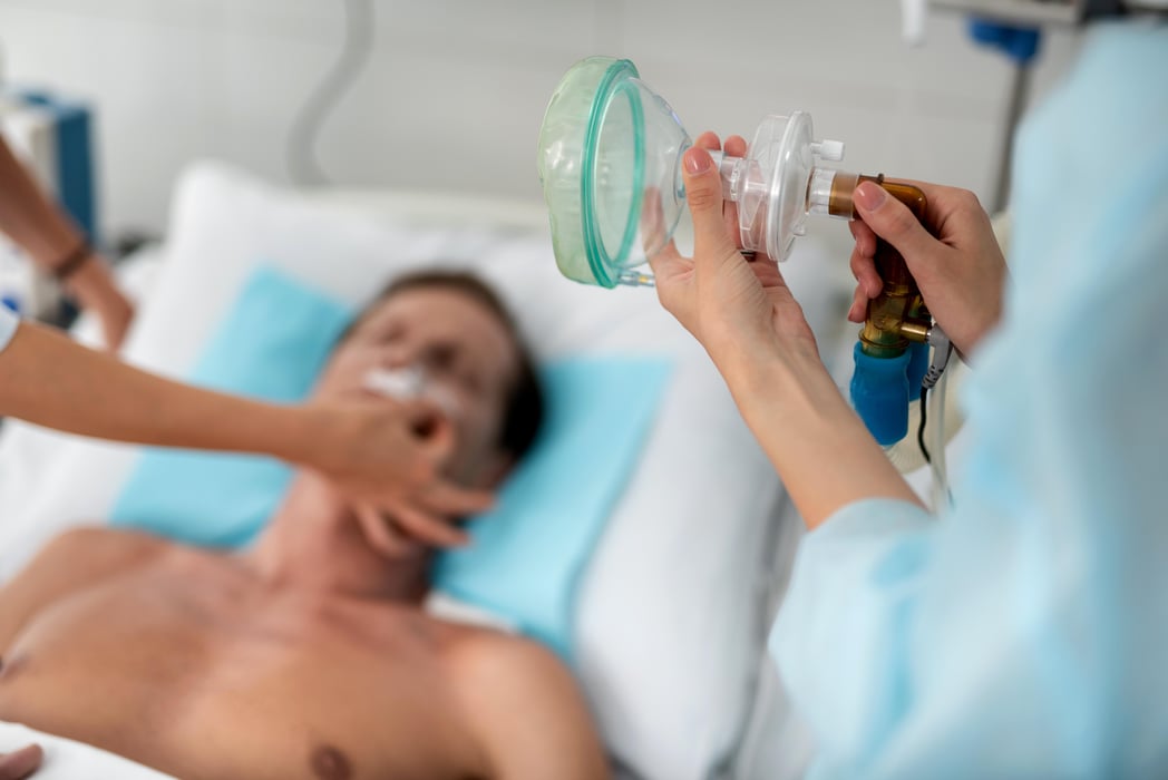 Nurse preparing oxygen mask for patient in critical state covid hospital