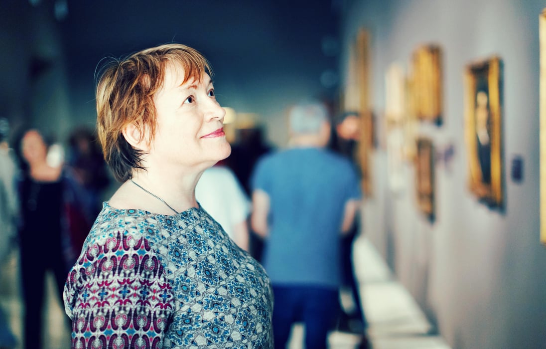 closeup on attentive senior woman visiting museum and enjoying a