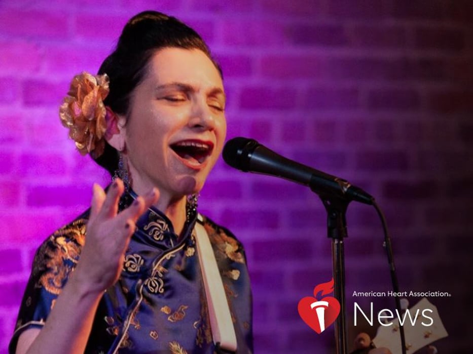 A woman singing into a microphone, photo credit as American Heart Association News