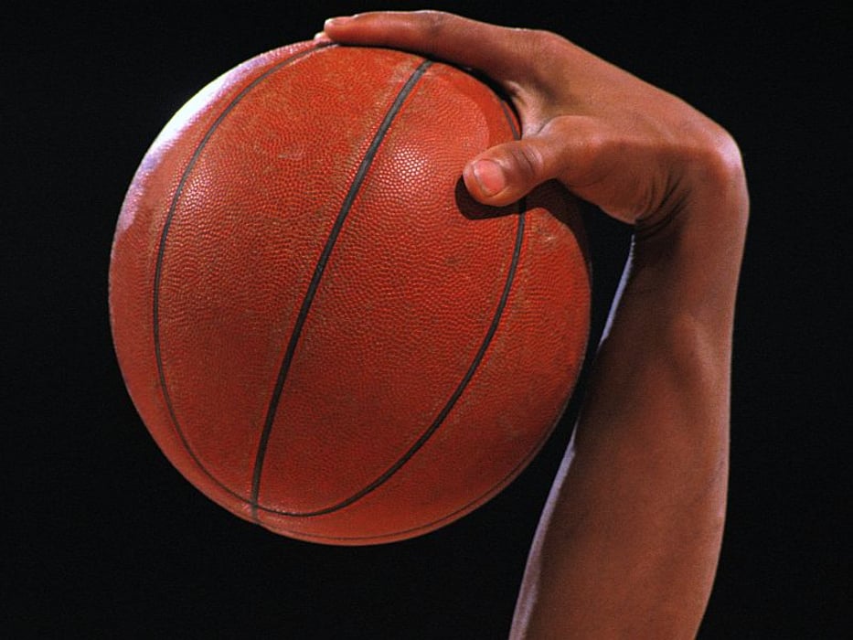 player palming basketball