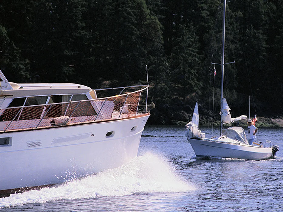 motorboat passing sailboat