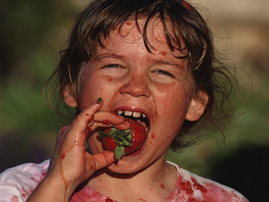 girl eating strawberry