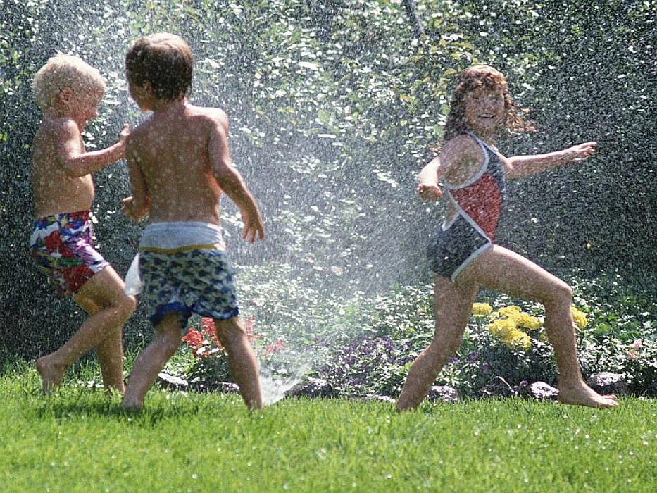 children in a sprinkler