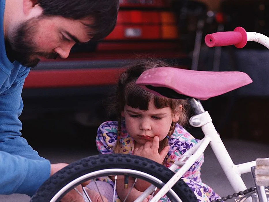 parent fixing girl bike