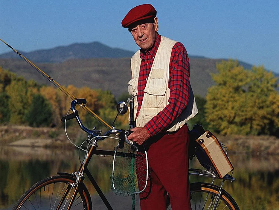 man with fishing-rod on a bike