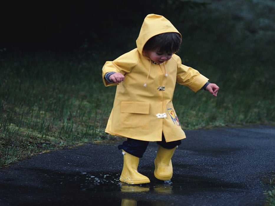 girl playing in a puddle