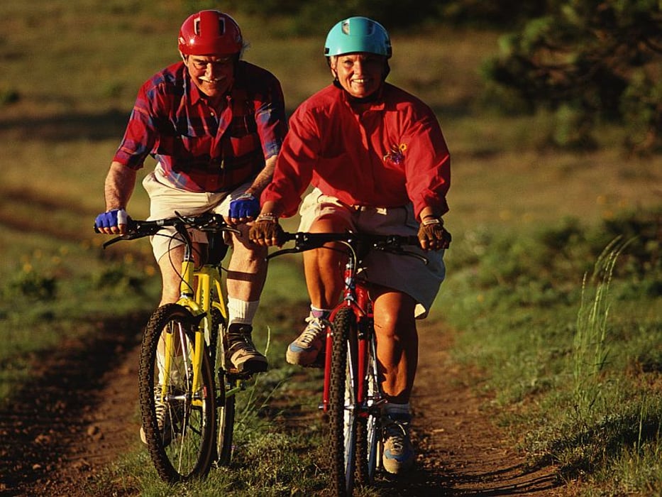 elderly couple cycling
