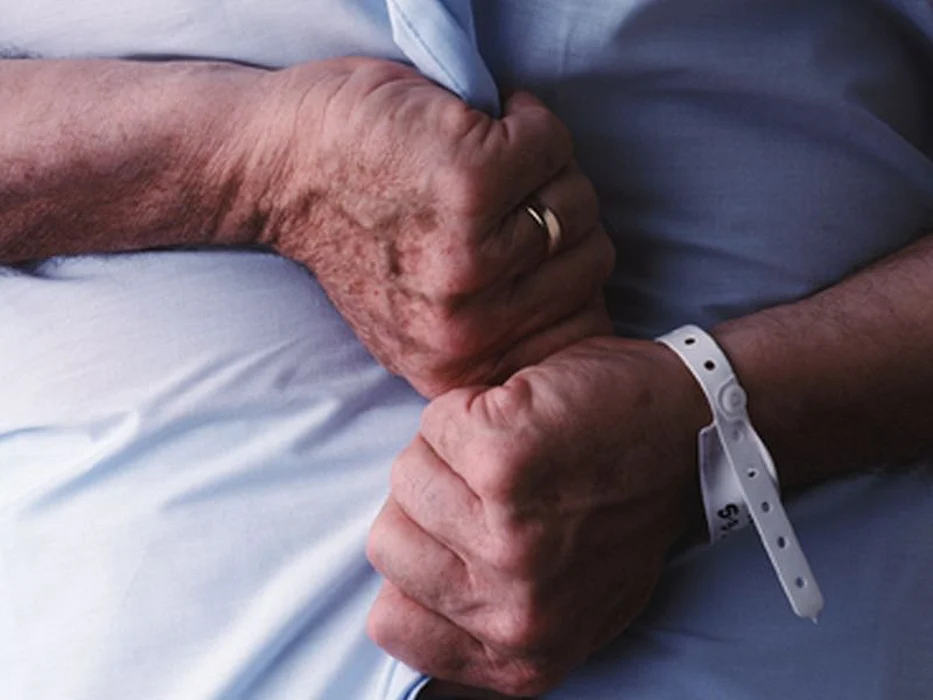 hands with a hospital wrist band