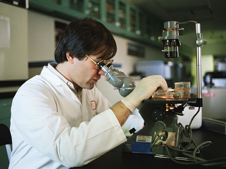 man looking through the microscope