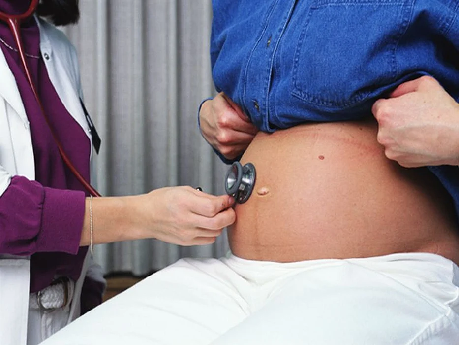 doctor examining pregnant woman