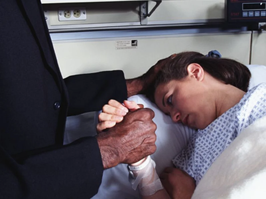 priest tending to patient