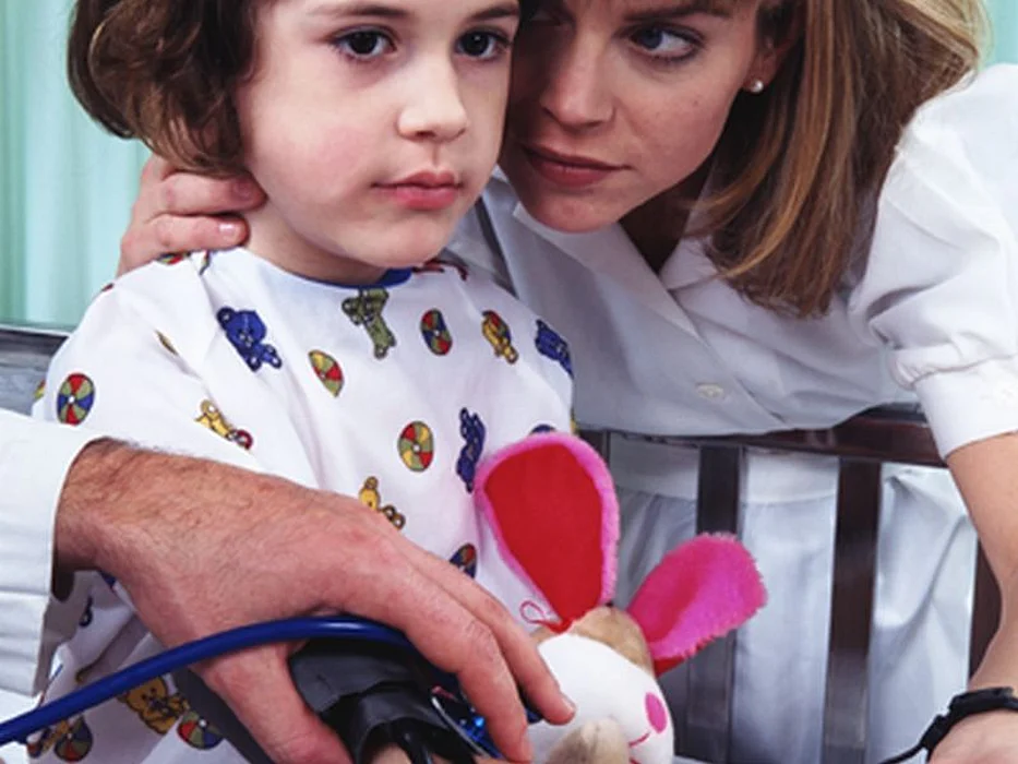 checking blood pressure of a little girl