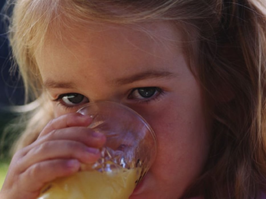 girl drinking an orange juice