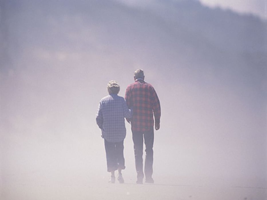elderly couple surrounded by fog