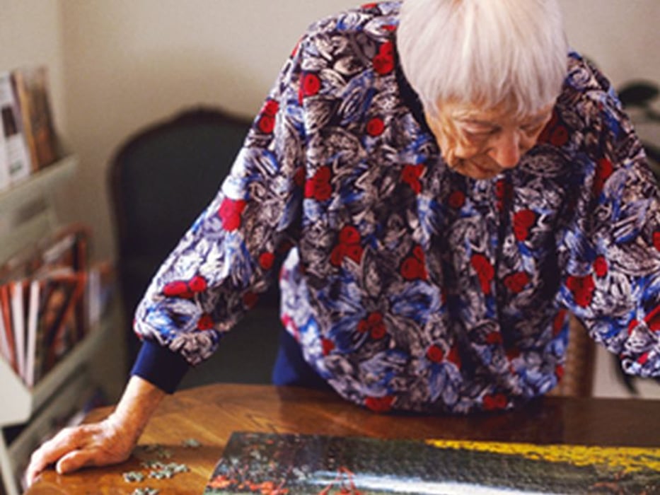 woman doing jigsaw puzzle