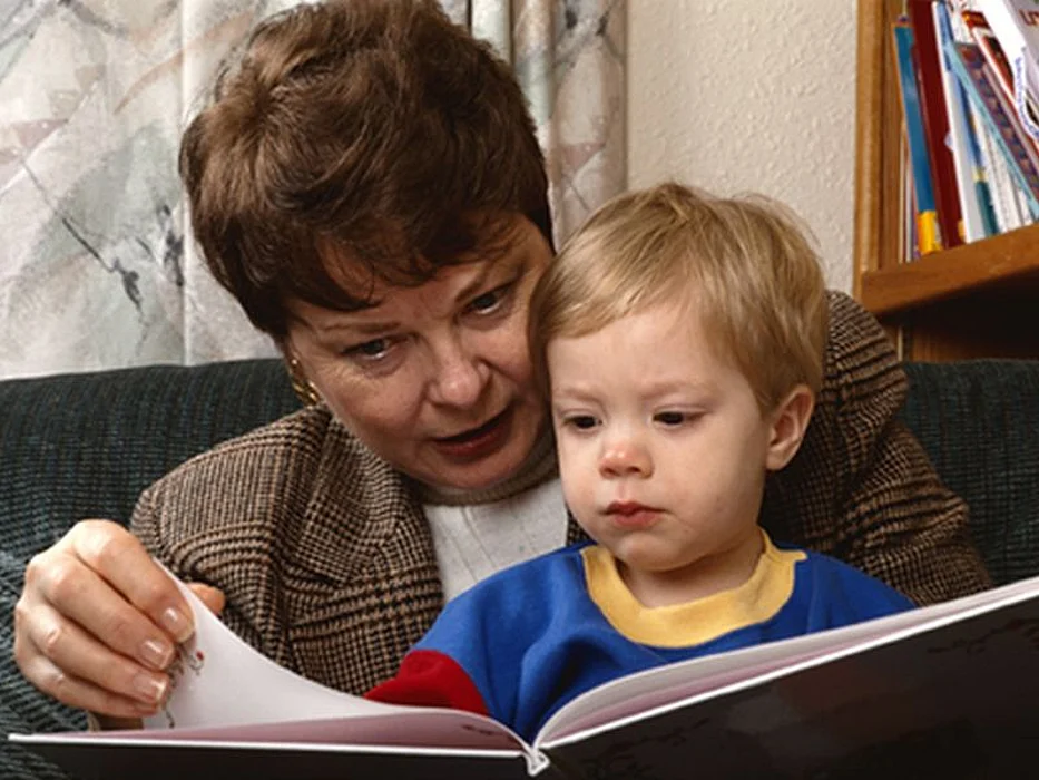 kid with a woman reading books