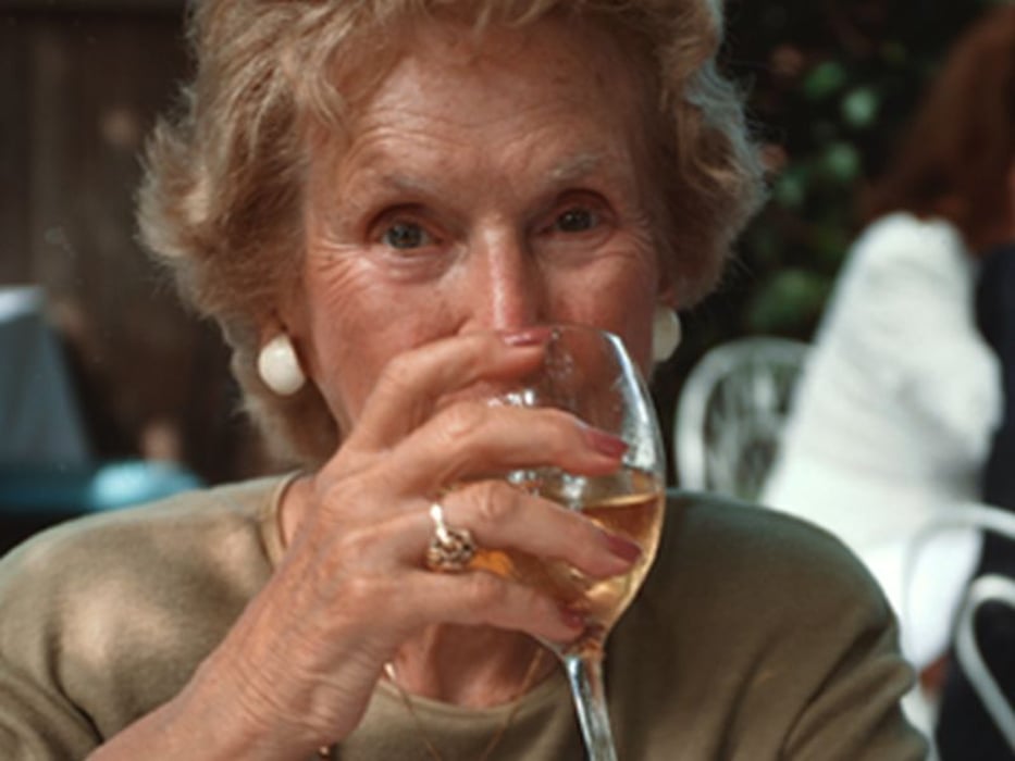 elderly woman drinking wine