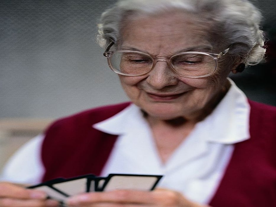 Elderly woman playing cards