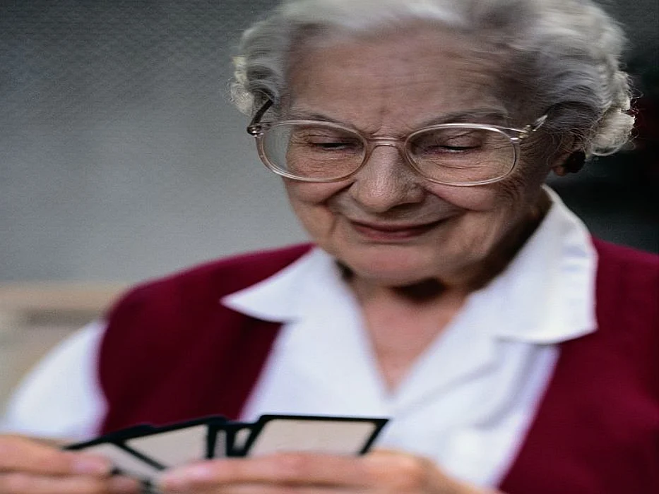 Elderly woman playing cards