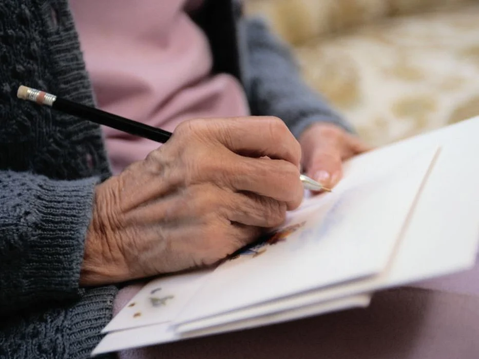 Senior writing a card