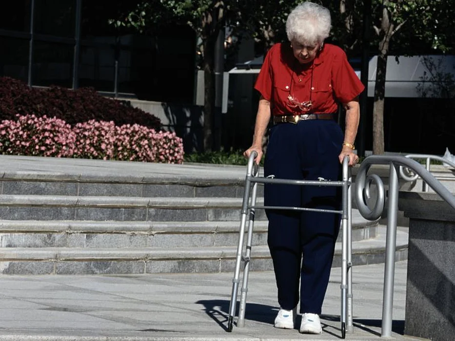 Elderly woman with a walker