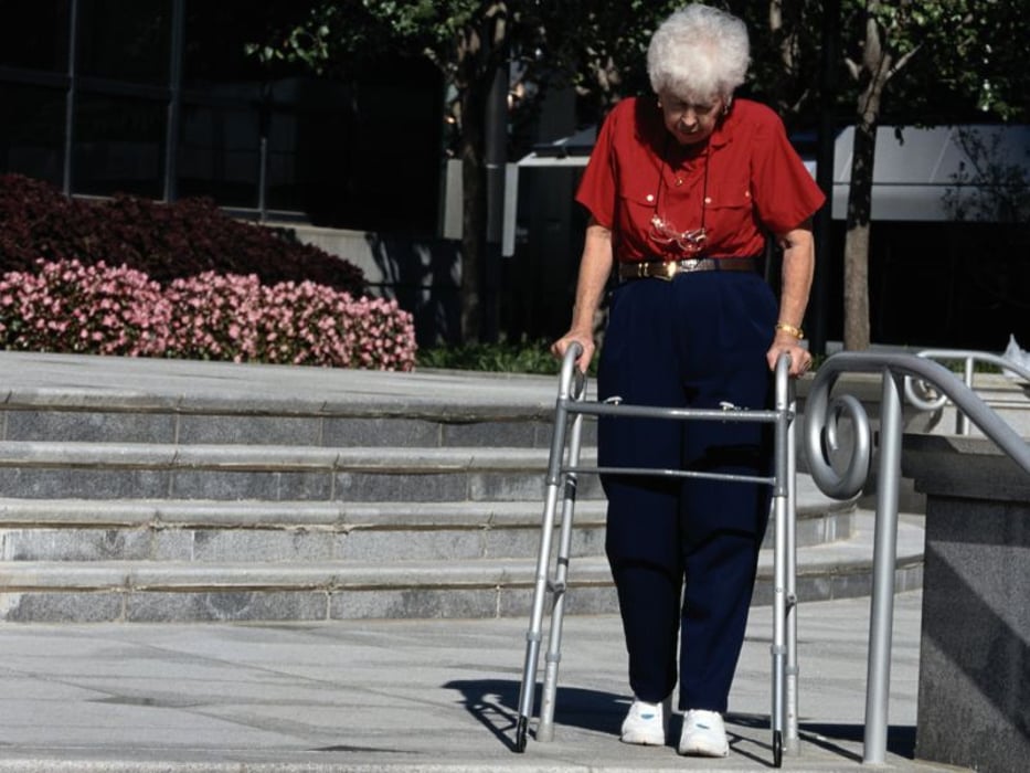 Elderly woman with a walker