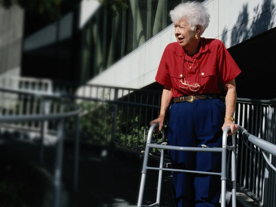 Elderly woman with a walker