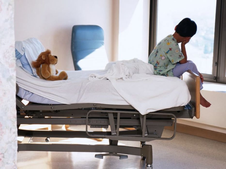 a child on a bed in a hospital