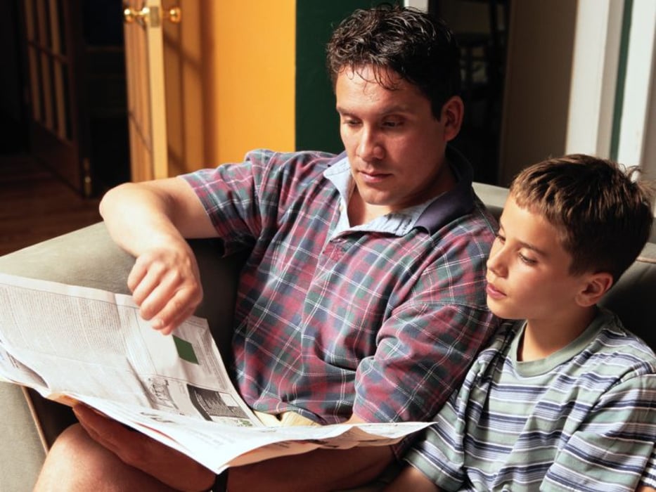 father and boy reading