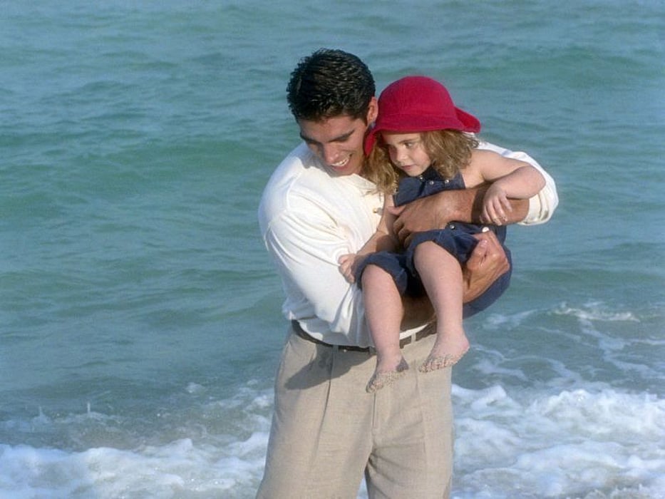 father and a girl at the beach