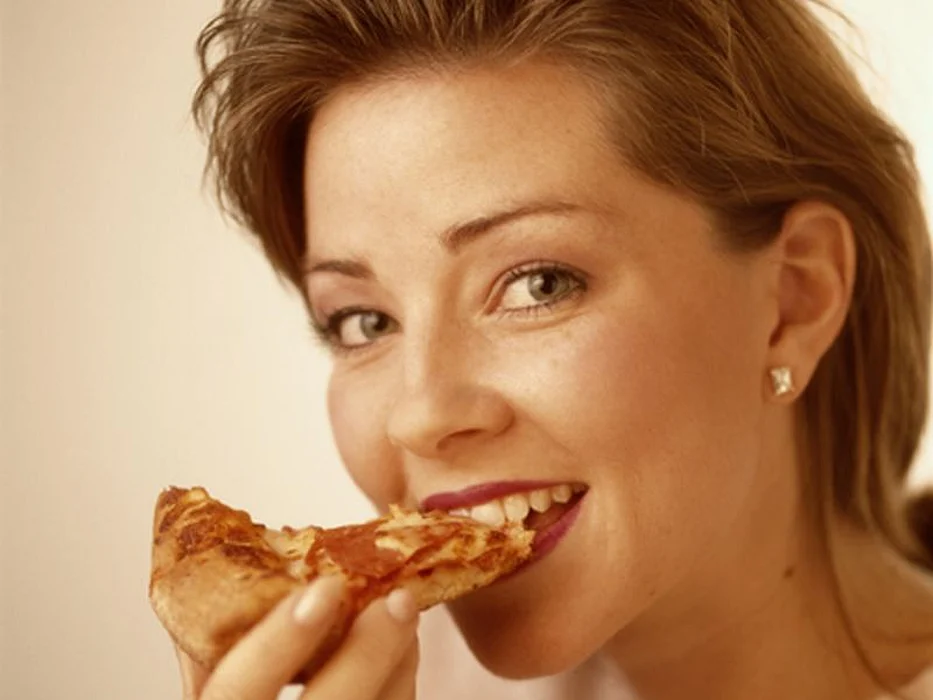 woman eating pizza