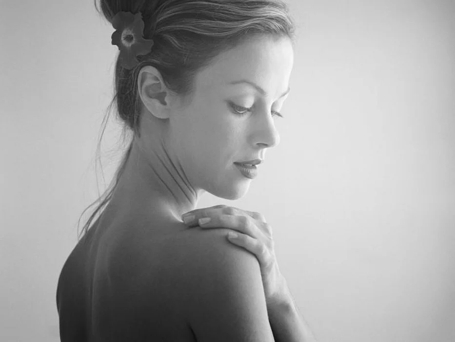 woman touching shoulder