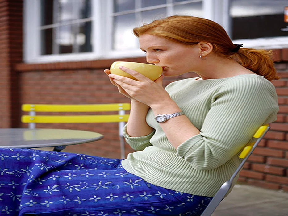 woman drinking from a bowl