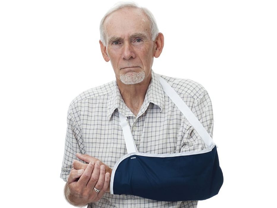 elderly man wearing sling